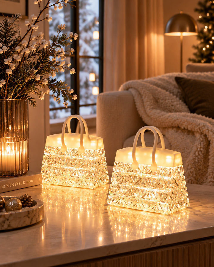 Two handbag night lights glowing on a console in a cosy living room