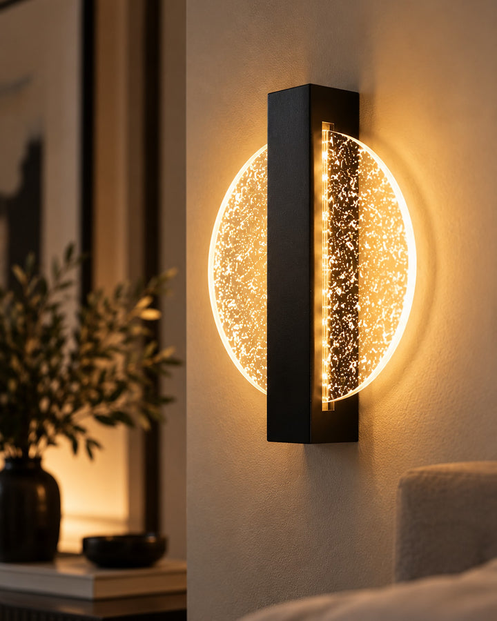 Luminous Halo wall light close-up with amber glow and gold-flecked disc