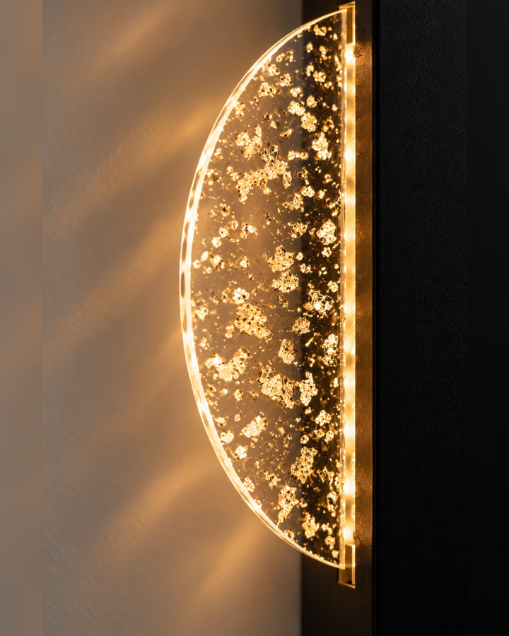 Edge detail of the Luminous Halo wall light showing gold flakes in the glowing disc