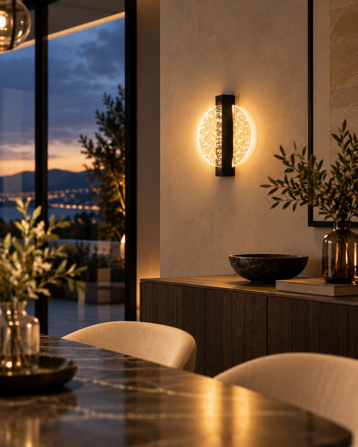 Luminous Halo wall light above a dining table with an evening city view
