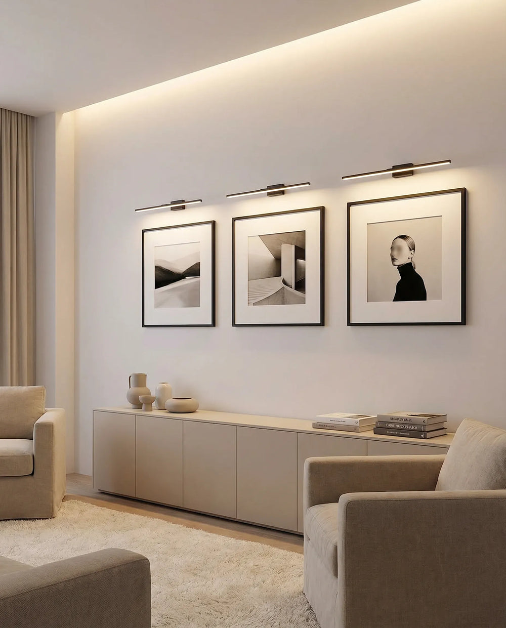 Three black LED picture lights above framed black and white art in a living room