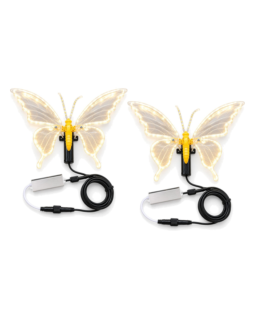 Two LED butterfly lamps glowing warm white with their cables on a white background