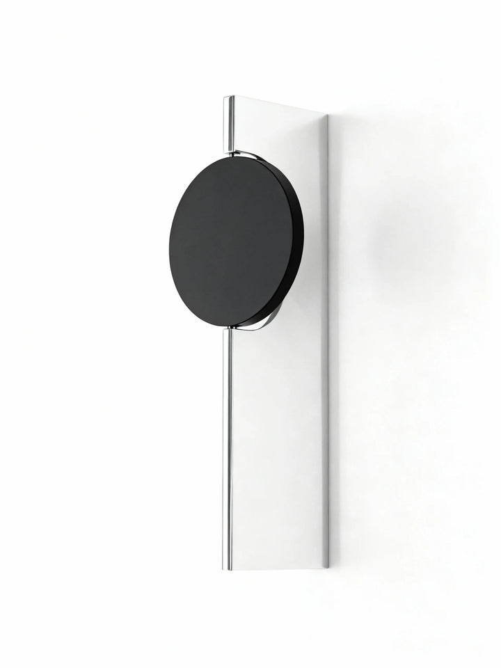 Single head halo wall lamp with one black disc on a slim mirrored backplate, white background