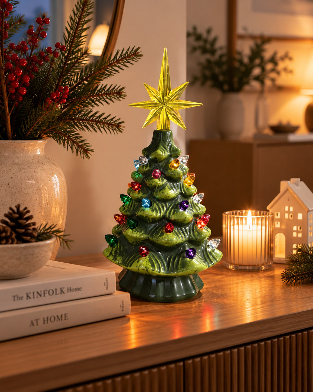 Ceramic Christmas tree on a wooden console with candles and pine branches