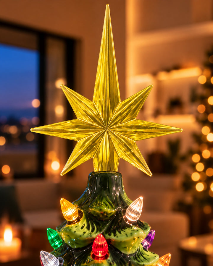 Close-up of the golden star topper and colored bulbs of the ceramic tree