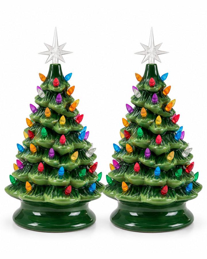 Pair of green ceramic Christmas trees with colourful bulbs and star toppers on a white background