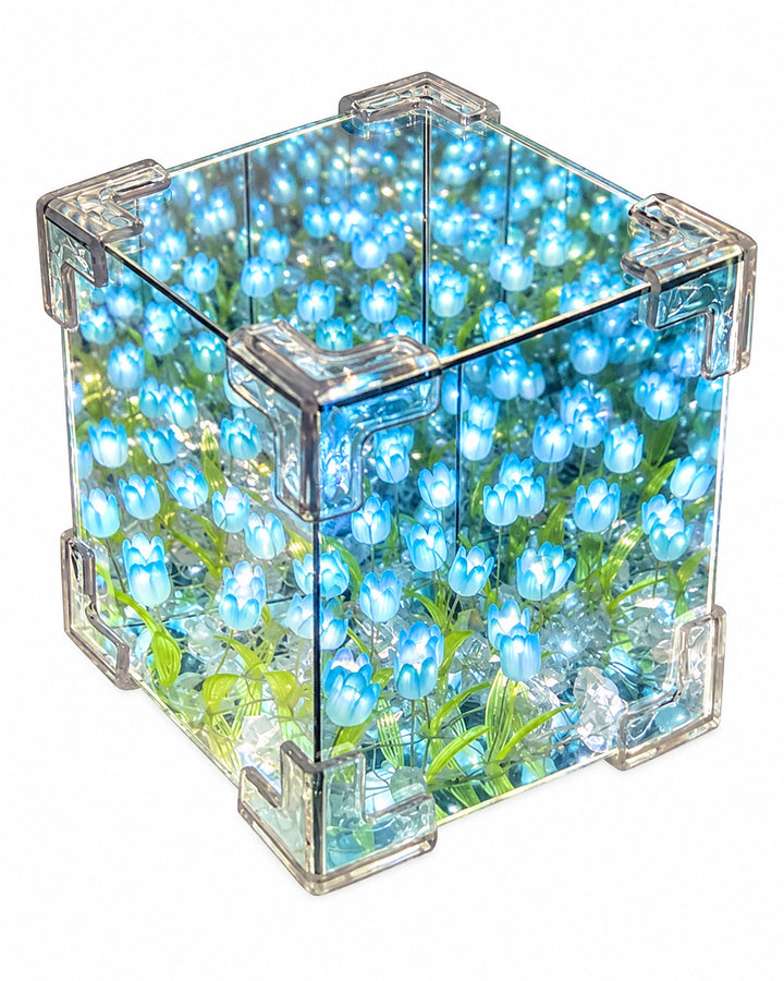 Tulip mirror cube with blue tulips seen from above, showing the glowing tulips reflected inside