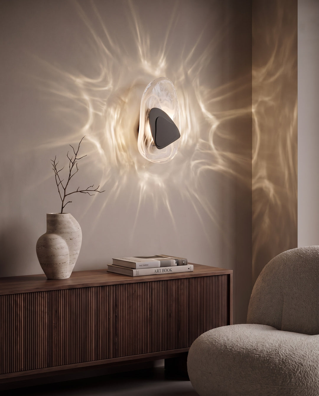 Black Ripple glass wall light casting water-like reflections above a fluted walnut sideboard