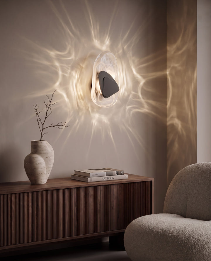 Black Ripple glass wall light casting water-like reflections above a fluted walnut sideboard