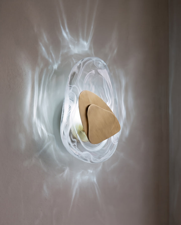 Gold Ripple wall light in cool white light, projecting water-like ripples on the wall