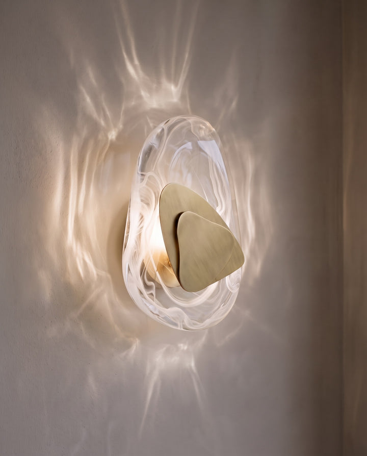 Gold Ripple wall light in natural white light, projecting water-like ripples on the wall