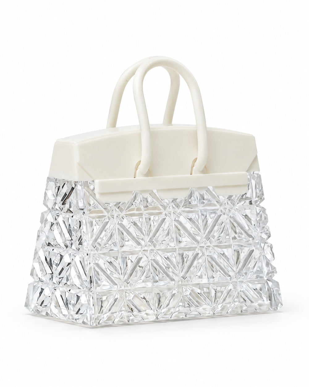Handbag-shaped night light with a faceted clear body and white handles, switched off, on a white background