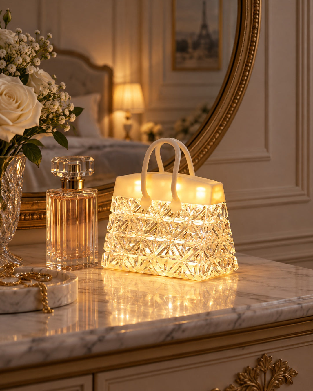 Handbag night light glowing on a marble dressing table beside a perfume bottle