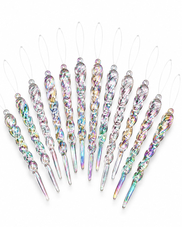 Iridescent twisted icicle ornaments fanned out on a white background