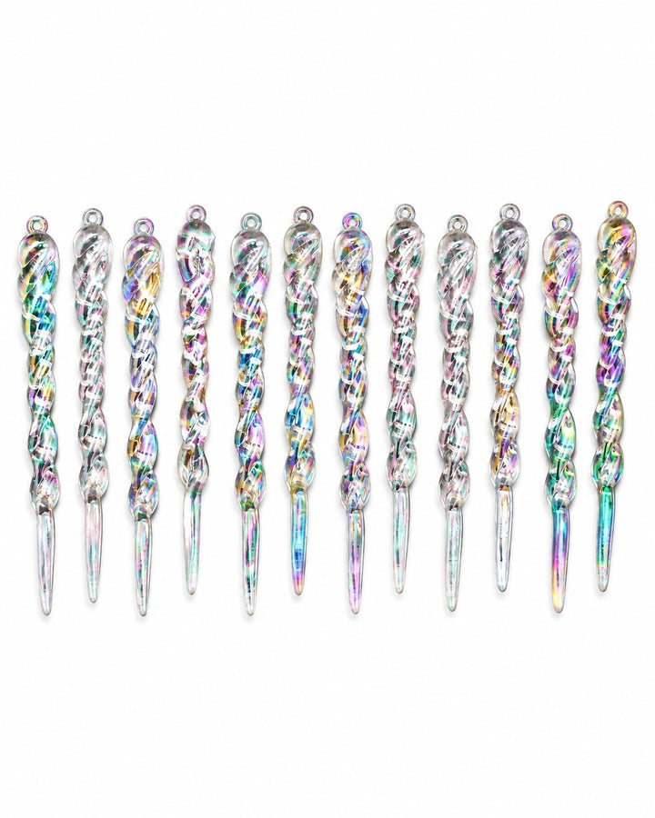 Iridescent icicle ornaments laid in a row, seen from above