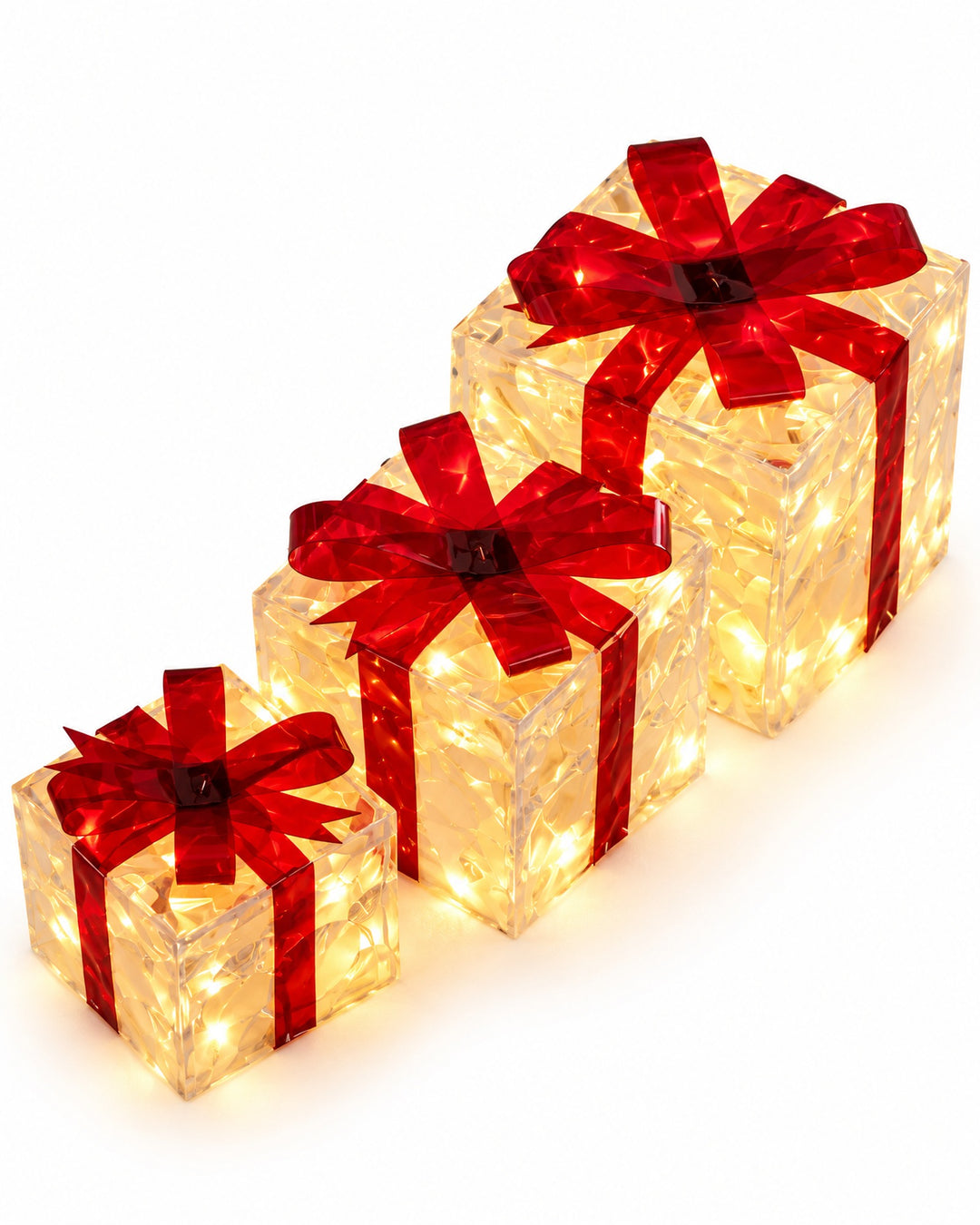 Set of 3 illuminated gift boxes with red bows on a white background