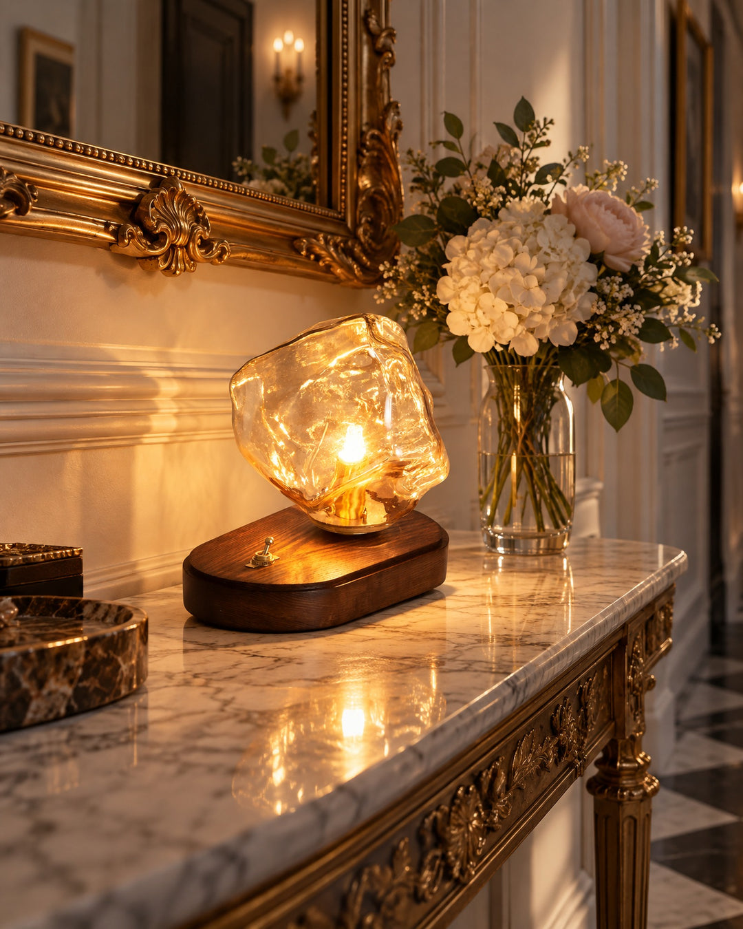 Ice rock glass lamp glowing on a marble console beneath a gilded mirror