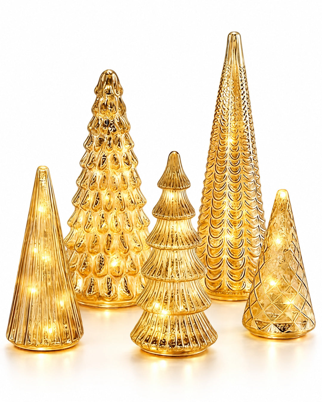 Set of five lit gold mercury glass Christmas trees of different heights on a white background
