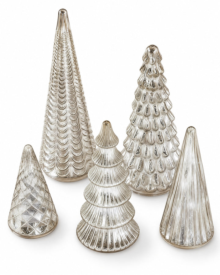 Five silver mercury glass trees seen from above on a white background