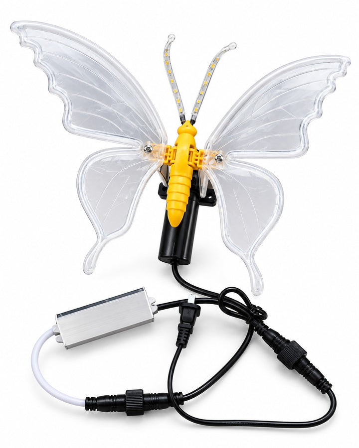LED butterfly lamp with translucent wings, switched off, with its cable and adapter on a white background