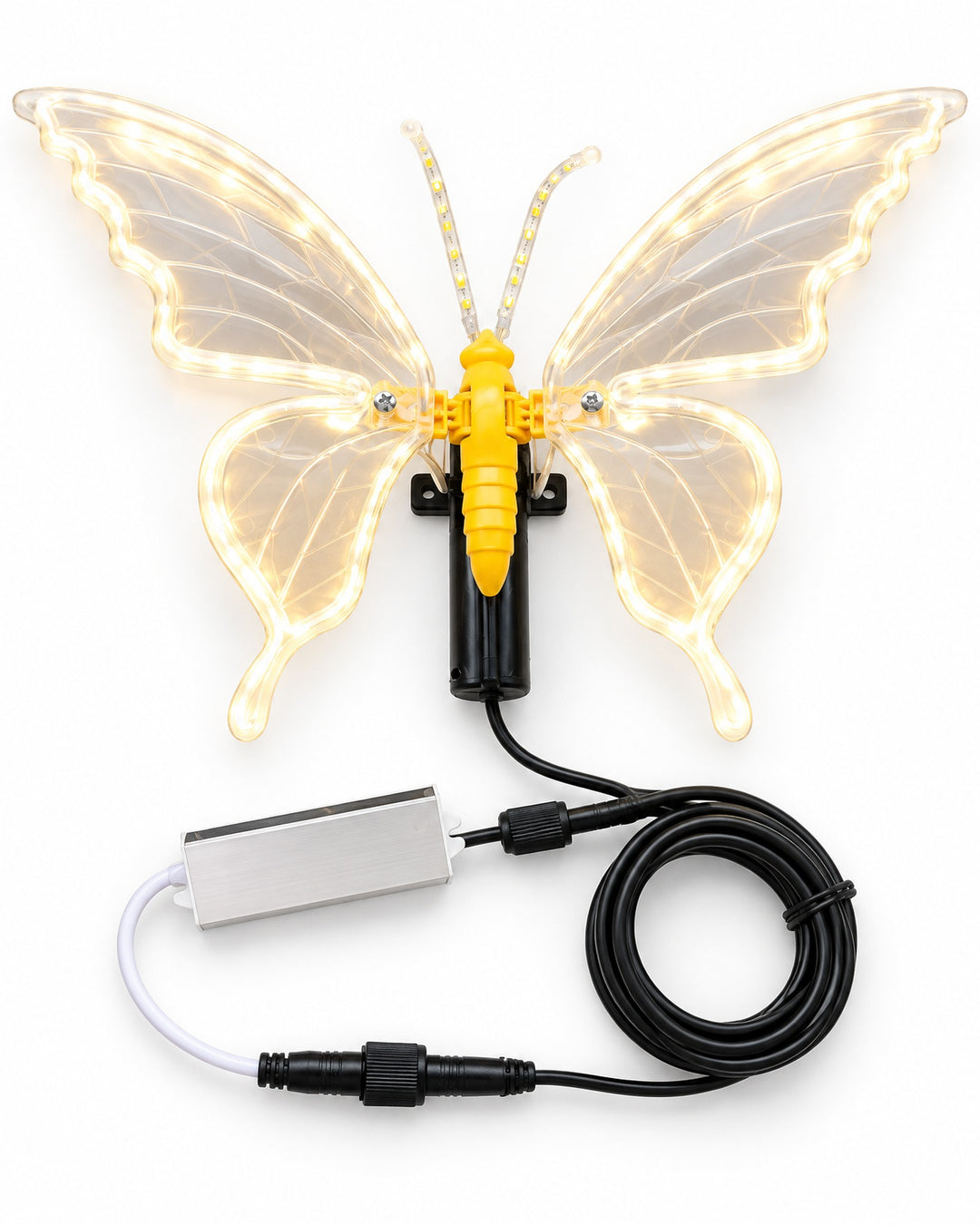 LED butterfly lamp glowing warm white, seen from above with its wings spread and the cable coiled