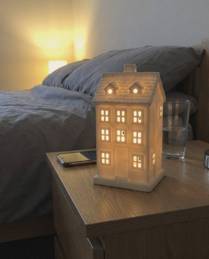 White ceramic Villa house used as a night light on an oak bedside table