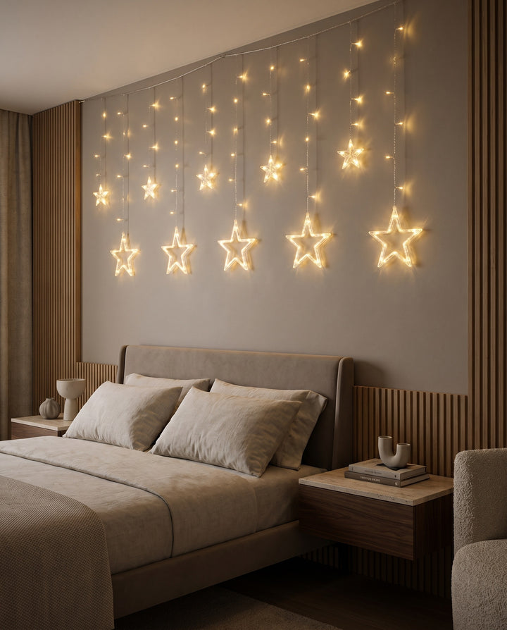 Warm white star curtain lights on the wall above a bed in a modern bedroom