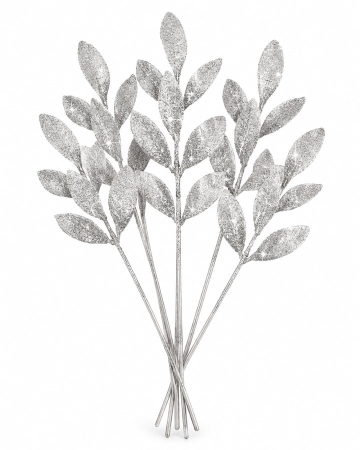 Bunch of silver glitter leaf picks on a white background