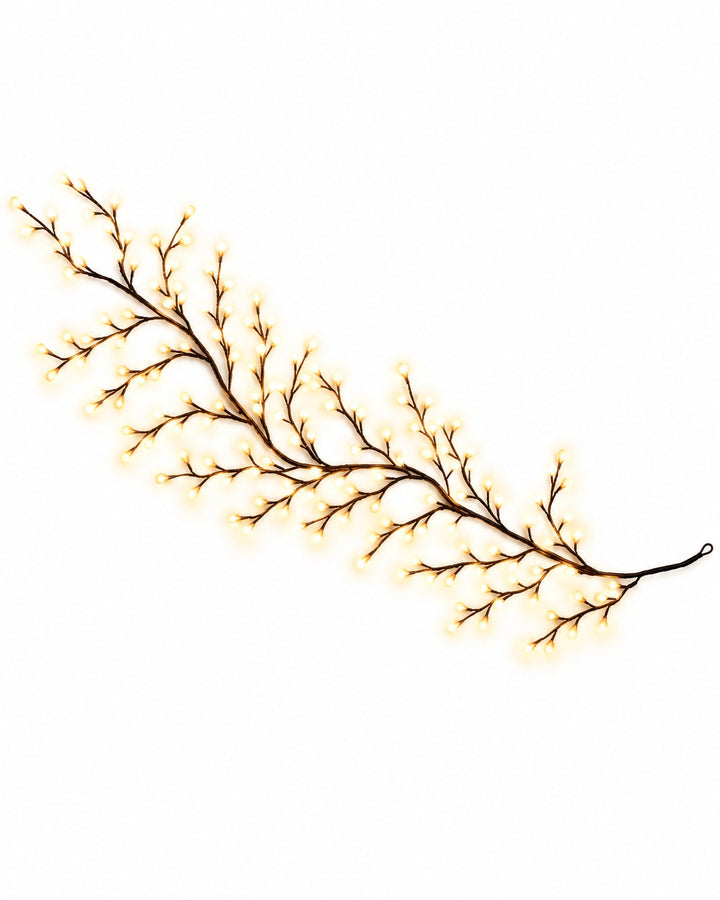 Willow vine light with tiny warm white LEDs on a white background