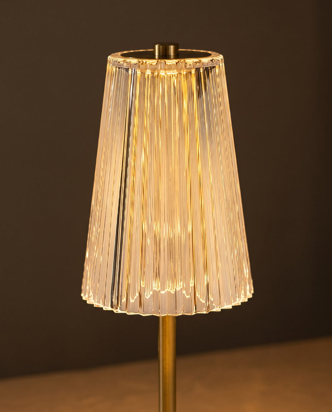 Close-up of the lit clear ribbed shade with its small cap