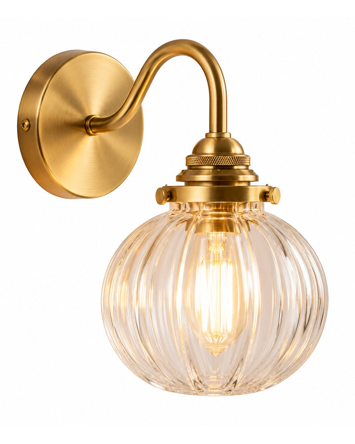 Gold-tone wall sconce with a ribbed clear glass globe on a white background