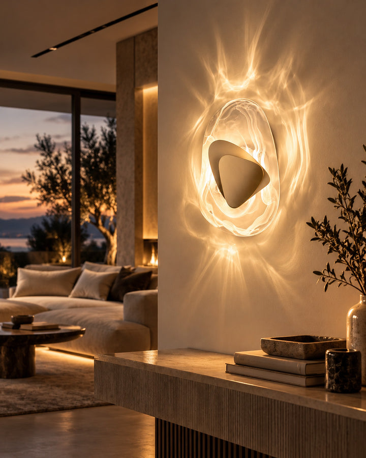 Gold Ripple glass wall light in warm white light glowing on a living room pillar at dusk
