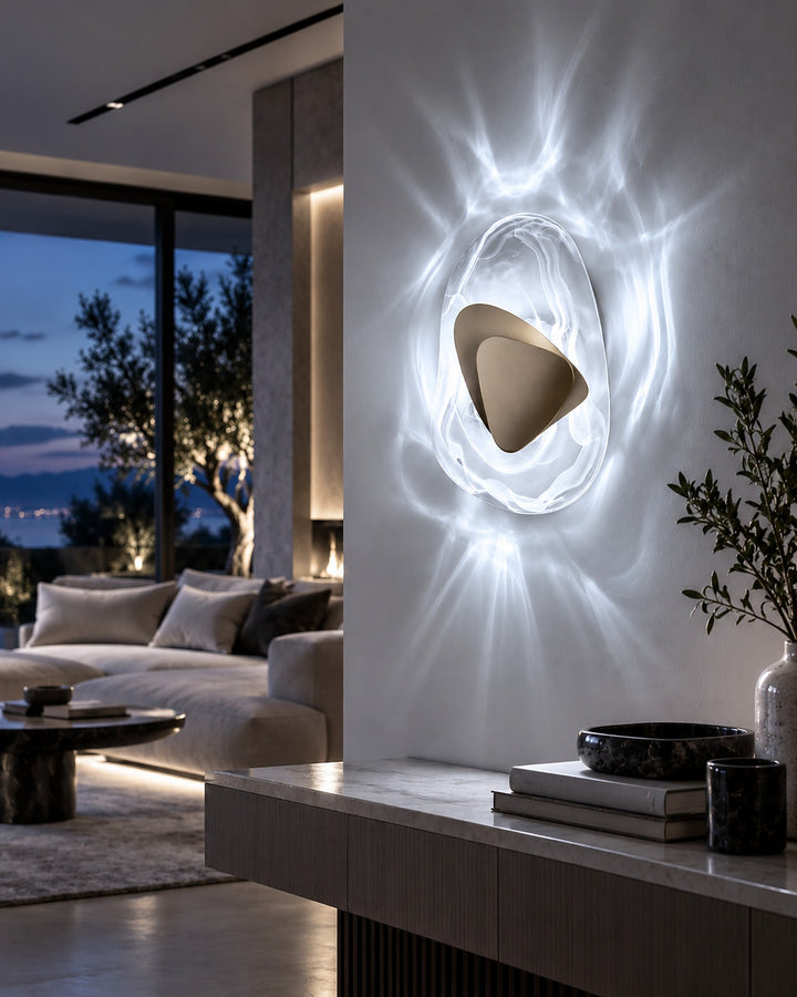 Gold Ripple glass wall light in cool white light on a living room pillar at dusk